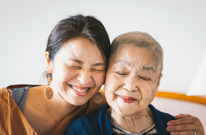 Two women hugging each other and smiling