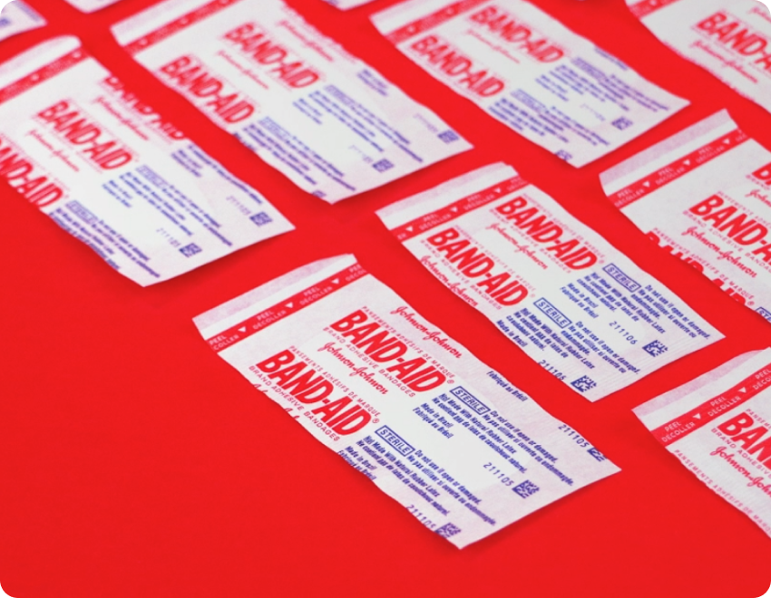 BAND-AID® Brand adhesive bandages on red background
